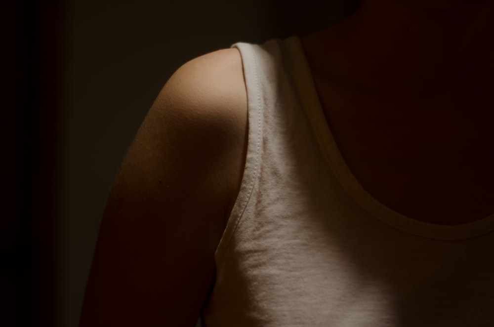 person wearing white tank top