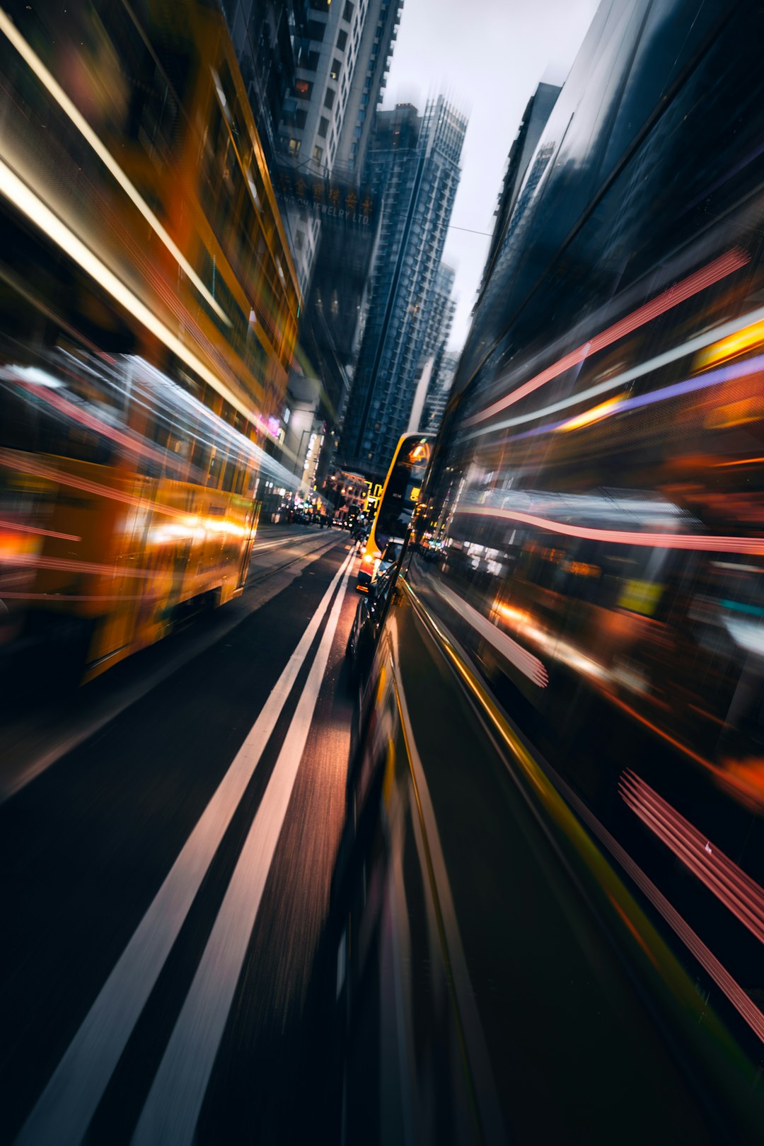 timelapse photography of cars on road surrounded by buildings