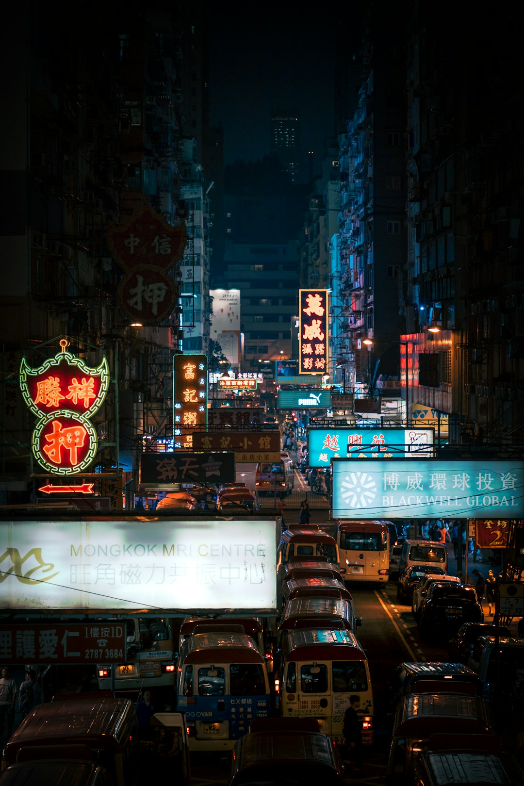 cars on road surrounded by buildings