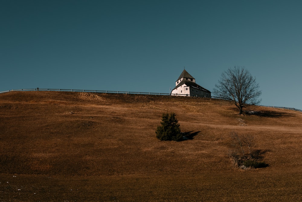 white and black house on top of hill