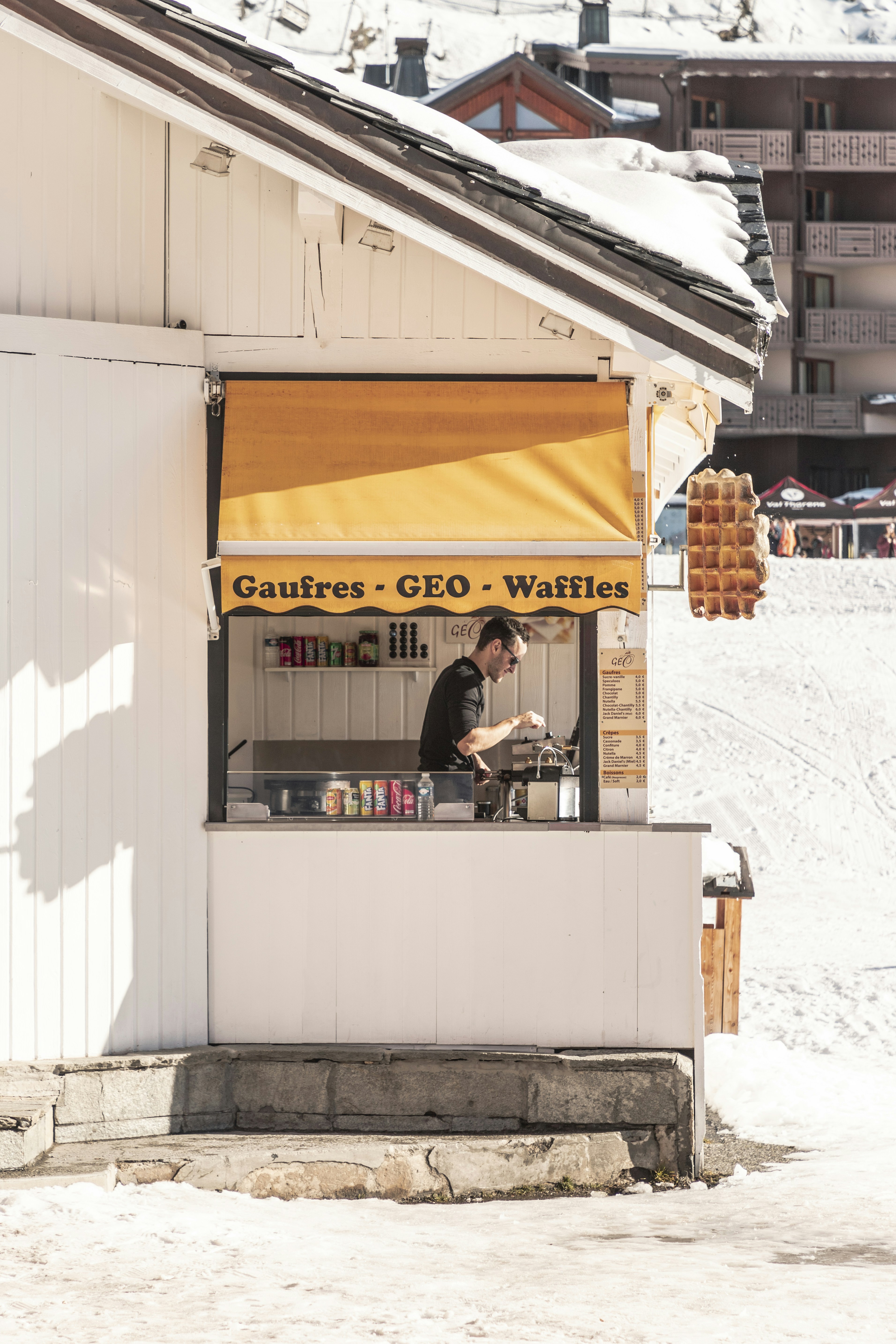 man on Gaufres Geo Waffles store during daytime