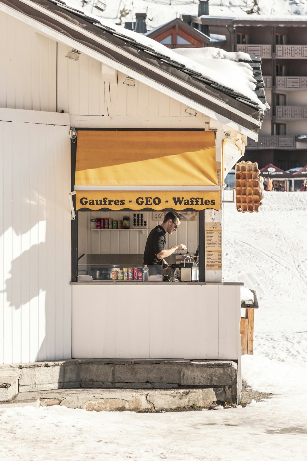 man on Gaufres Geo Waffles store during daytime
