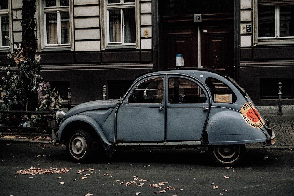 blue Volkswagen Beetle on park beside road