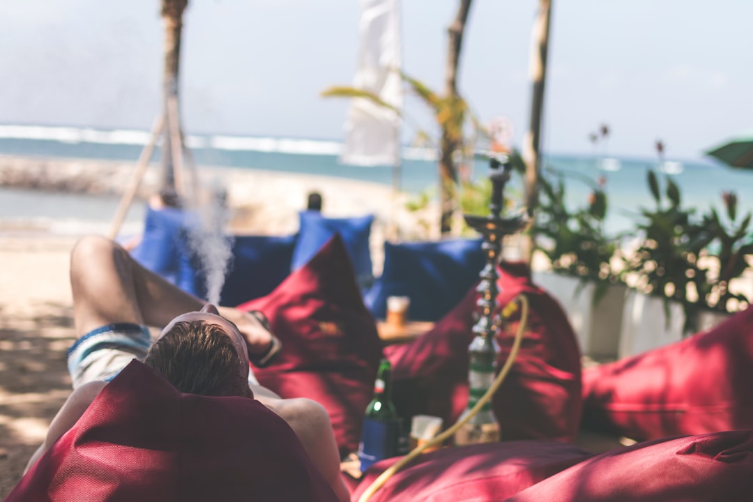 person lying on red bed during daytime