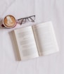 book near eyeglasses and cappuccino