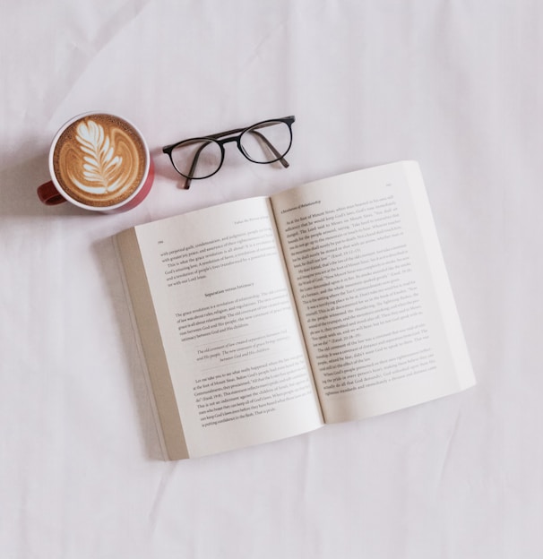 book near eyeglasses and cappuccino