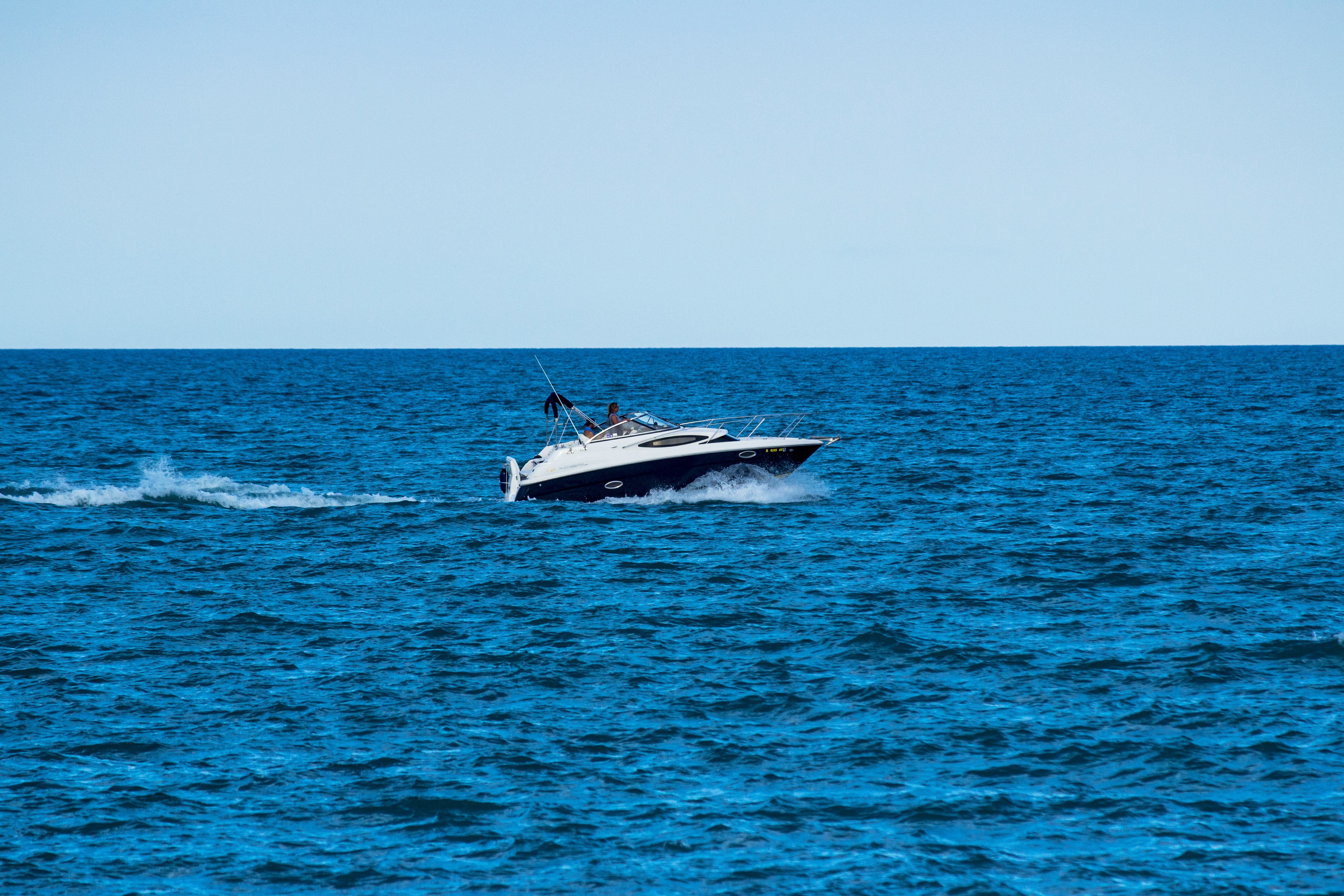 white speedboat on sea during daytime