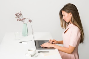 woman sitting while using laptop