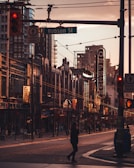 person walking on street under Robson St. signage