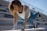 A happy woman exercising outdoors, showcasing her fitness journey.