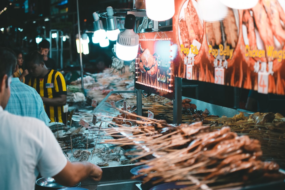 people standing near food stall