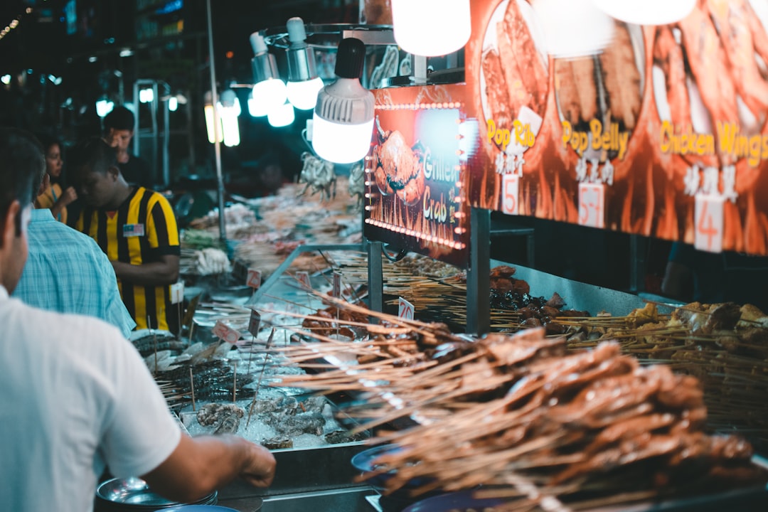 people standing near food stall,