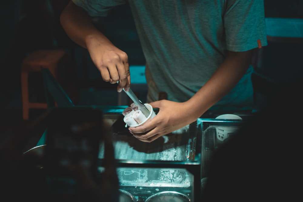 person holding fried ice cream in paper cup