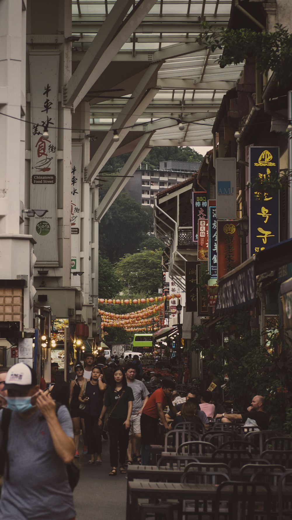 people walking on alley under metal shed during daytime