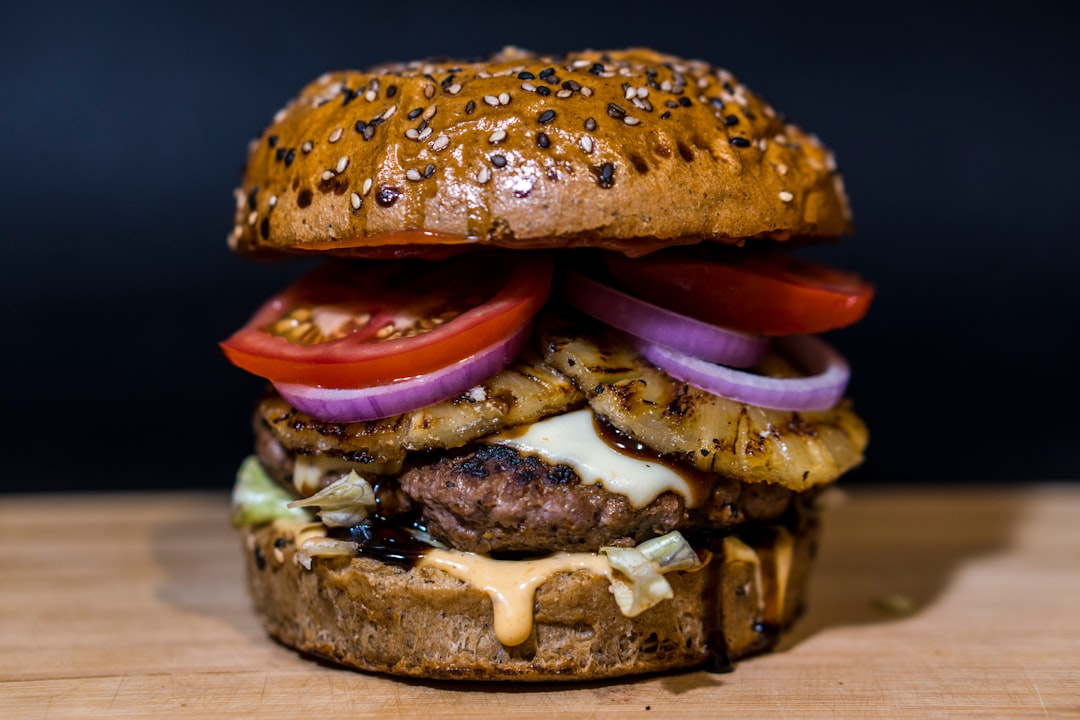 baked burger on brown surface