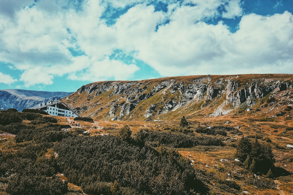 house near the cliff of the mountain