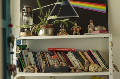 A small shelf displaying meaningful books and handmade crafts