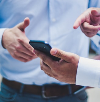 person holding black smartphone