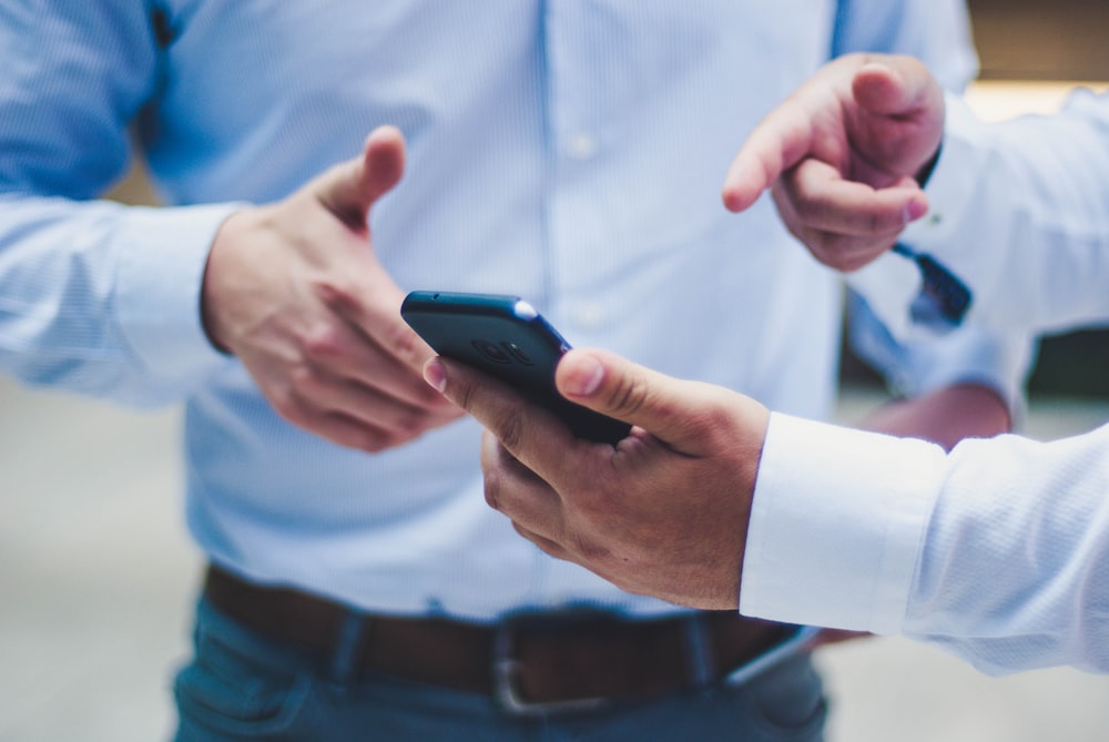 Daily News | Online News person holding black smartphone