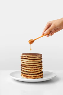 pancake with honey and honey dipper