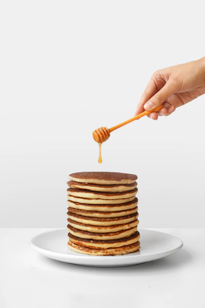 pancake with honey and honey dipper