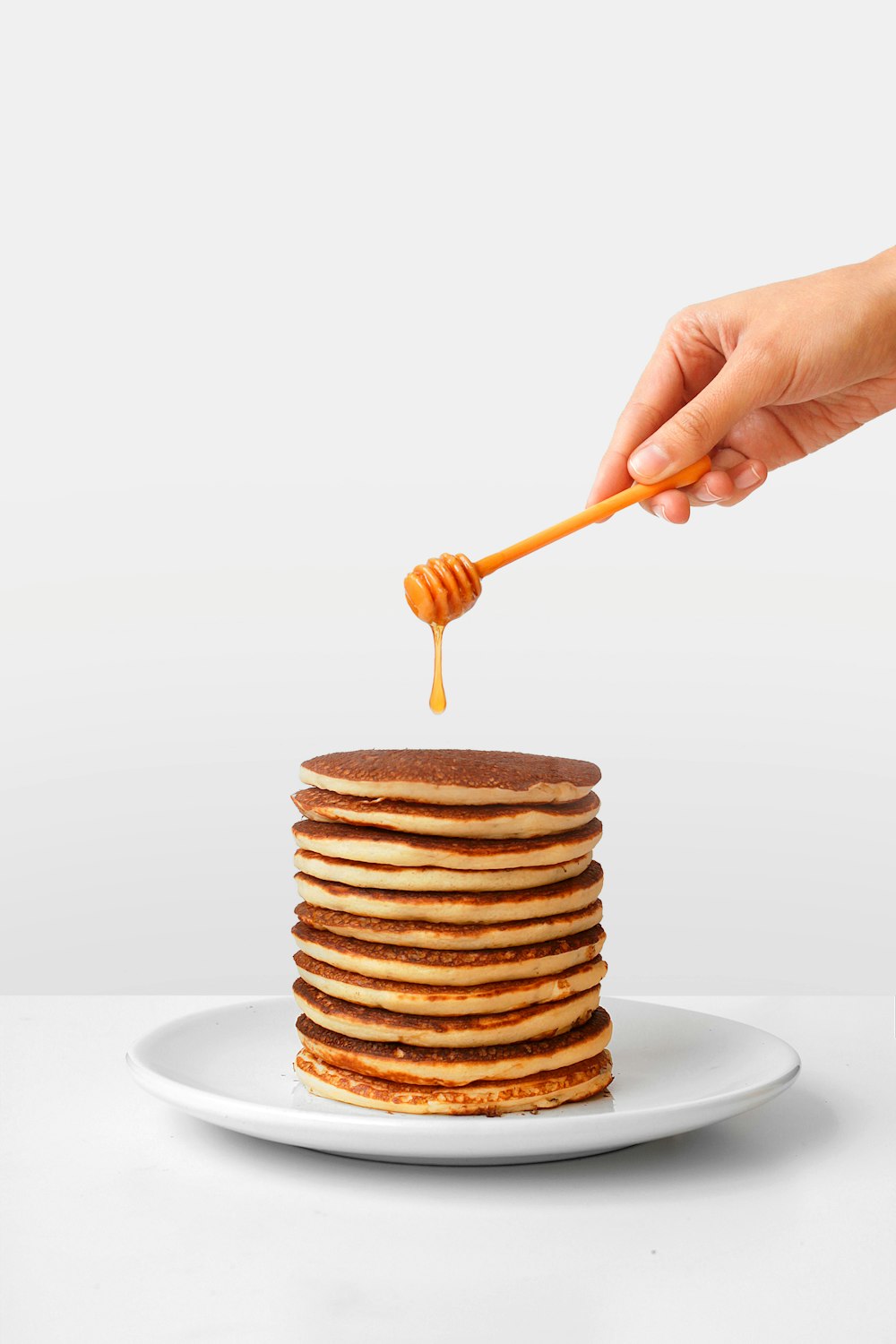 pancake with honey and honey dipper