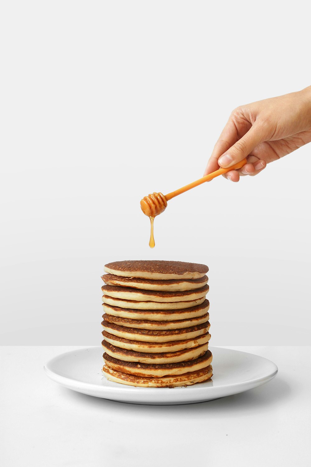 pancake with honey and honey dipper