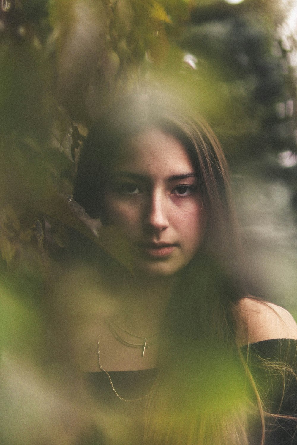 woman surrounded by green leafed plant