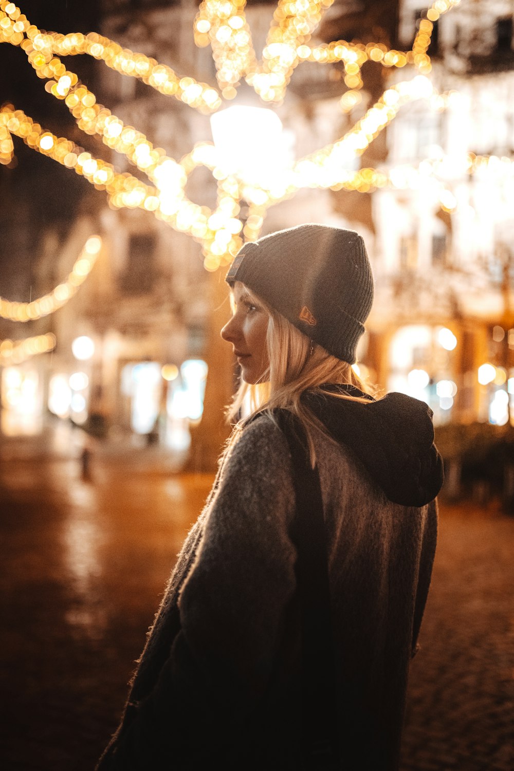 selective focus photography of woman standing wearing gray jacket and black knit capo