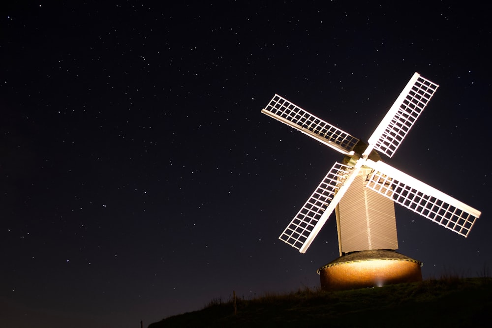 white wind turbine during nighttime