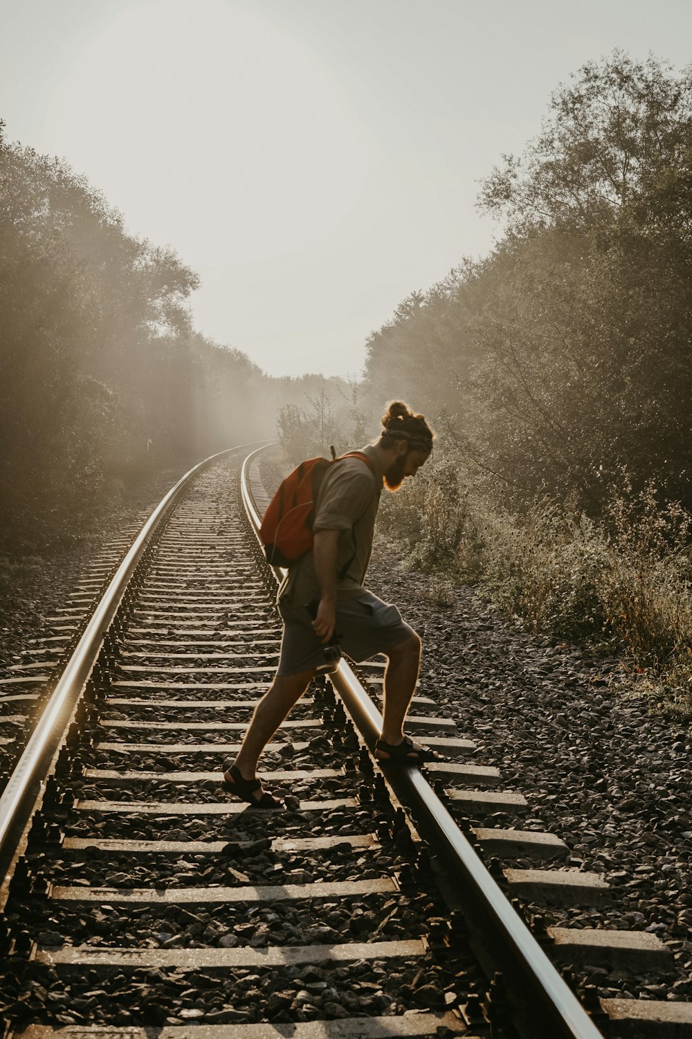 man overpassing train rail