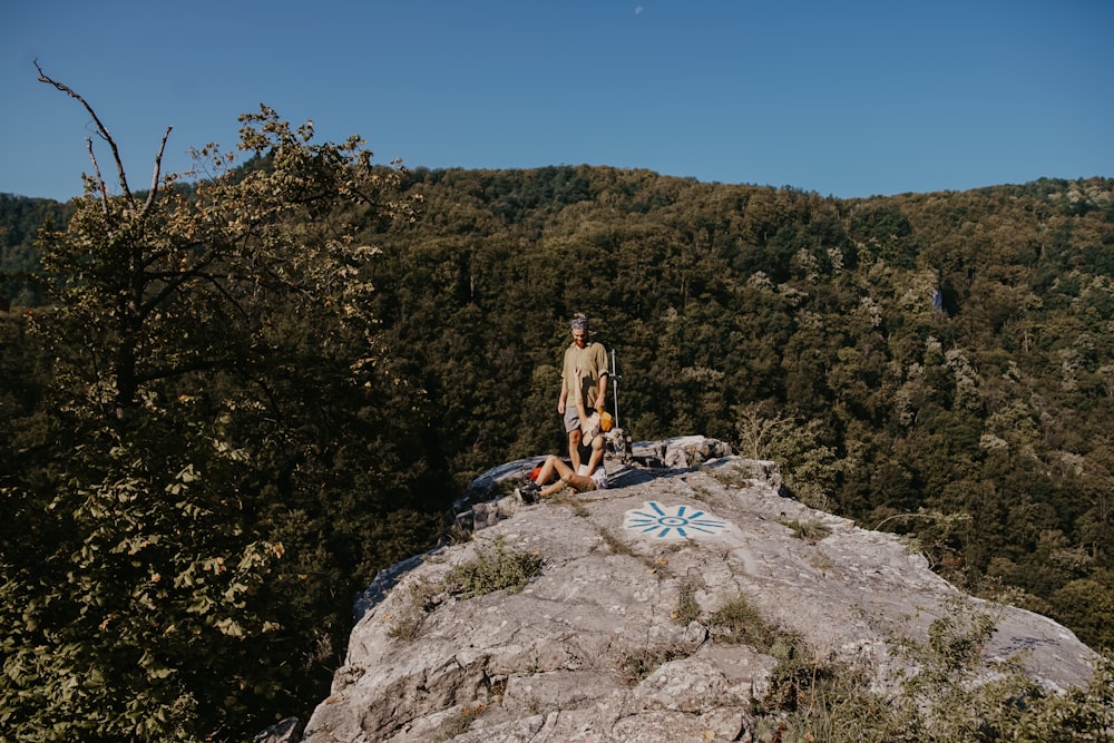woman standing on rock edge