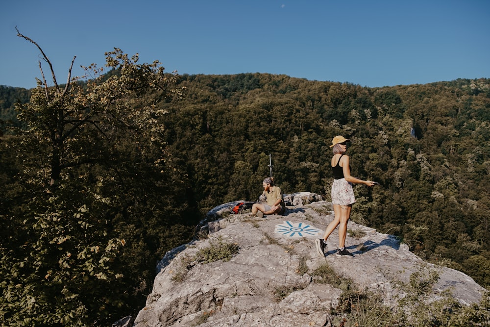 woman standing on mountain cliff