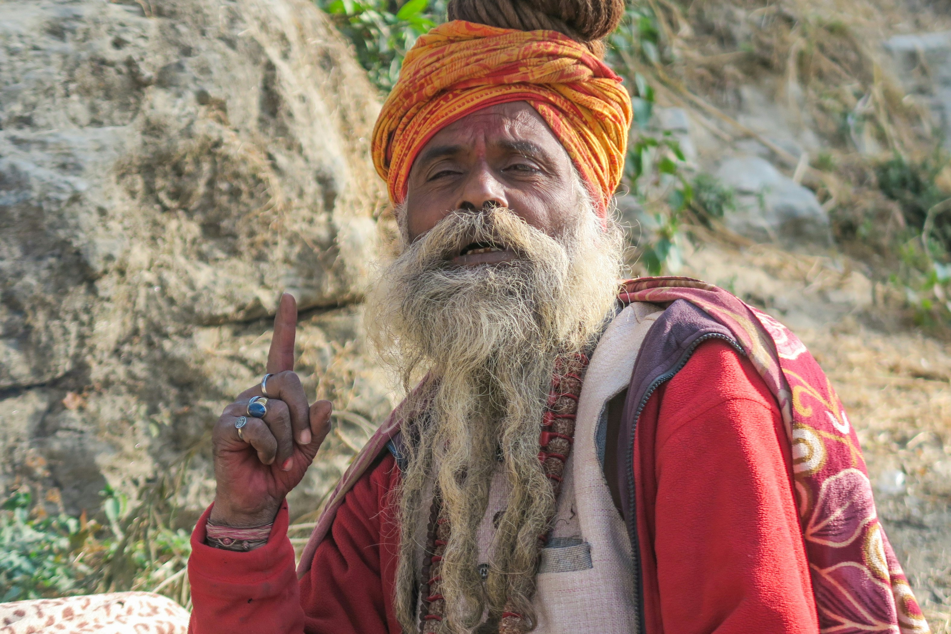 man wearing yellow turban and red jacket
