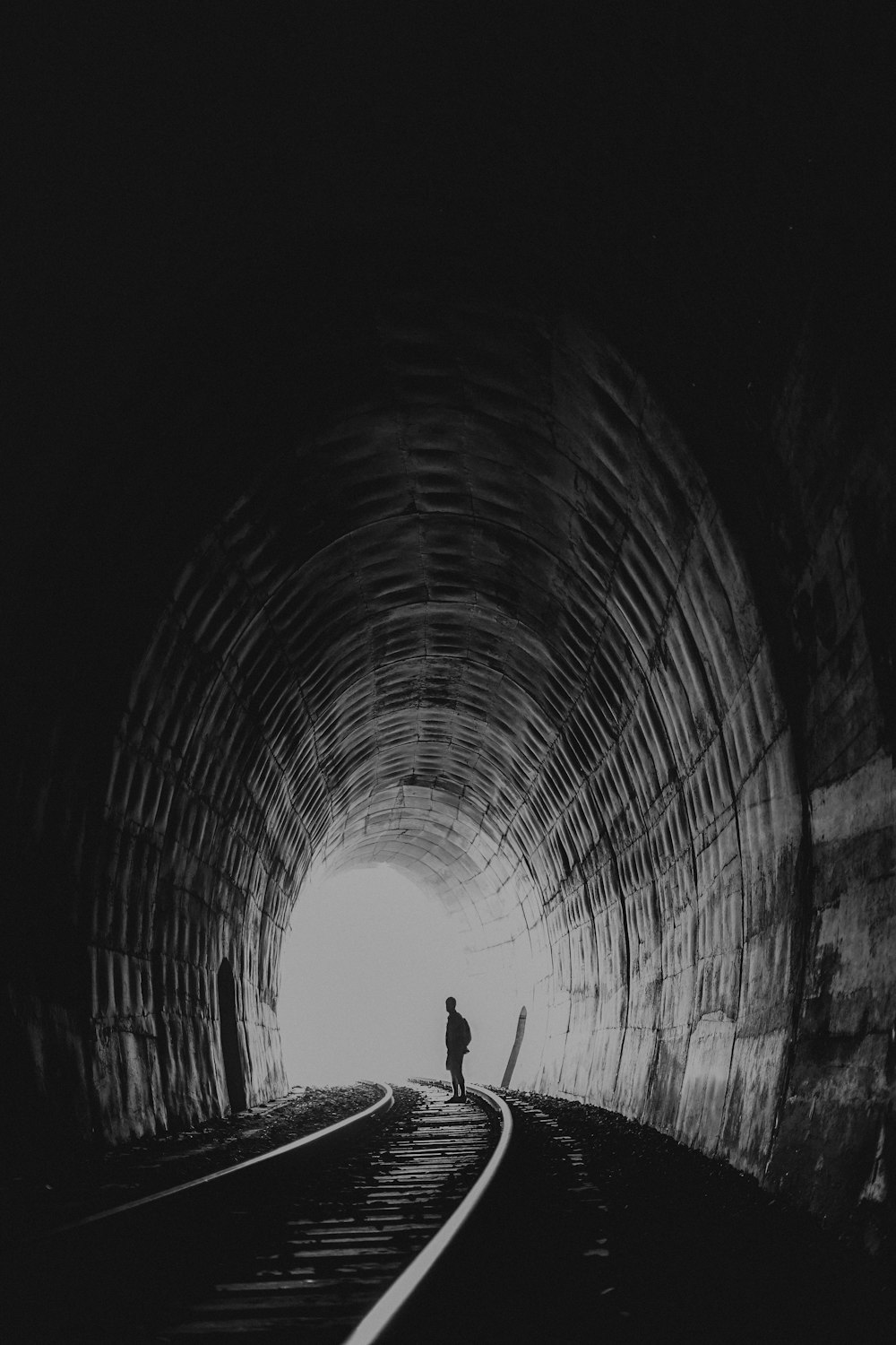 person standing in between road