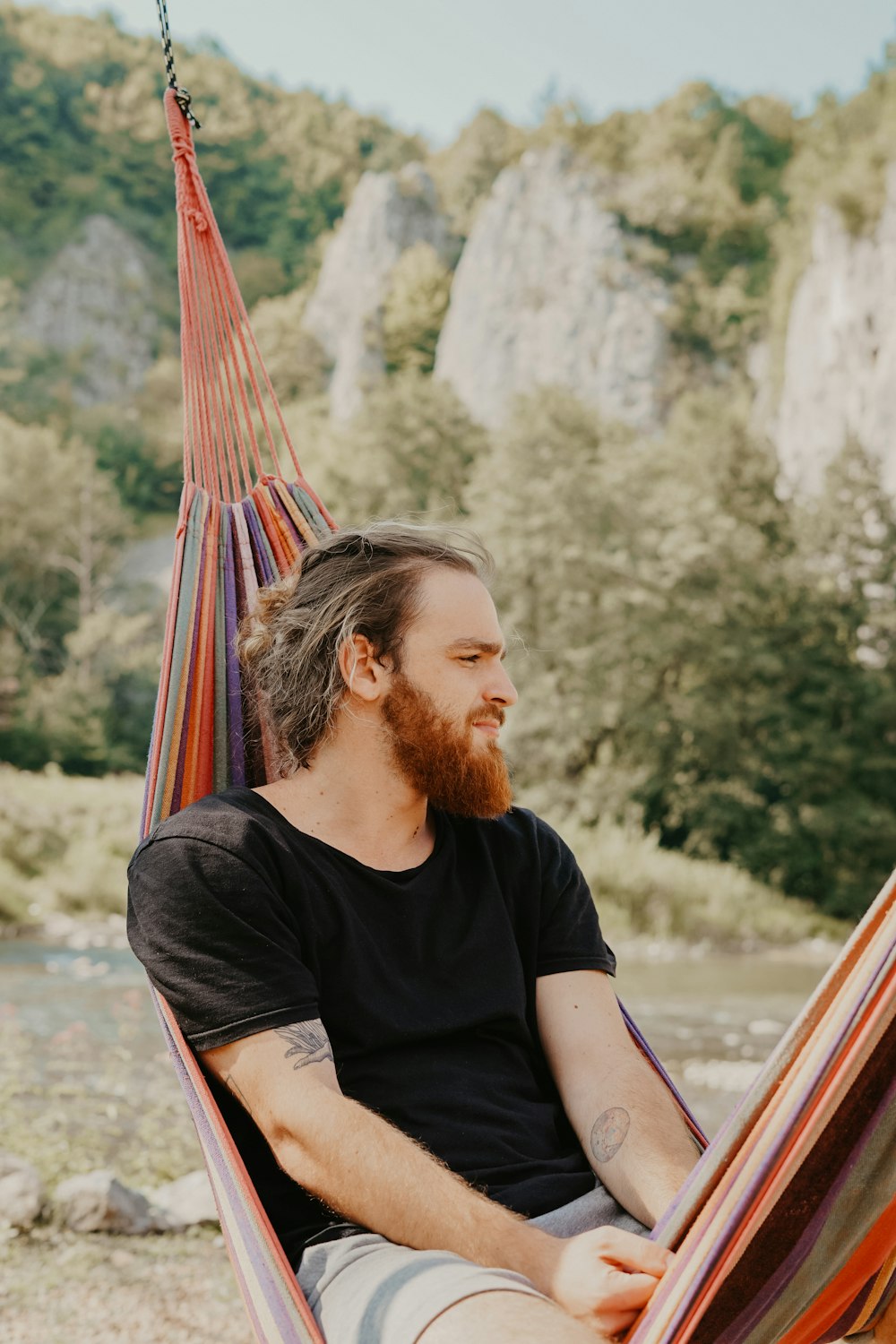 man lying on hammock outdoors