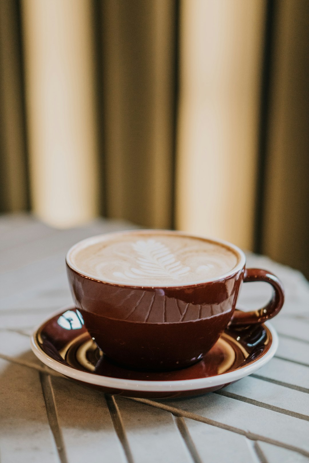 brown coffee cup on saucer