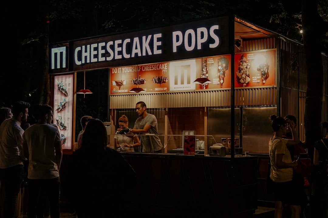Cheesecake Pops food stall with people at night