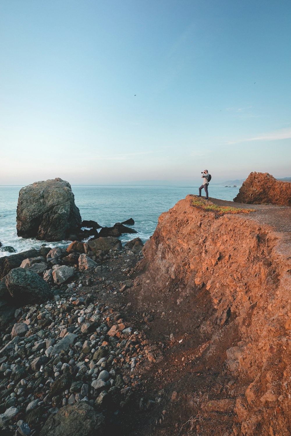 man standing near body of water during daytime