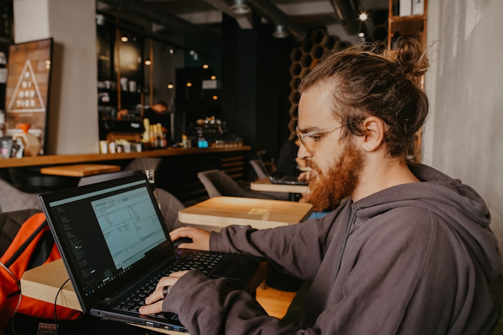 man using black laptop computer