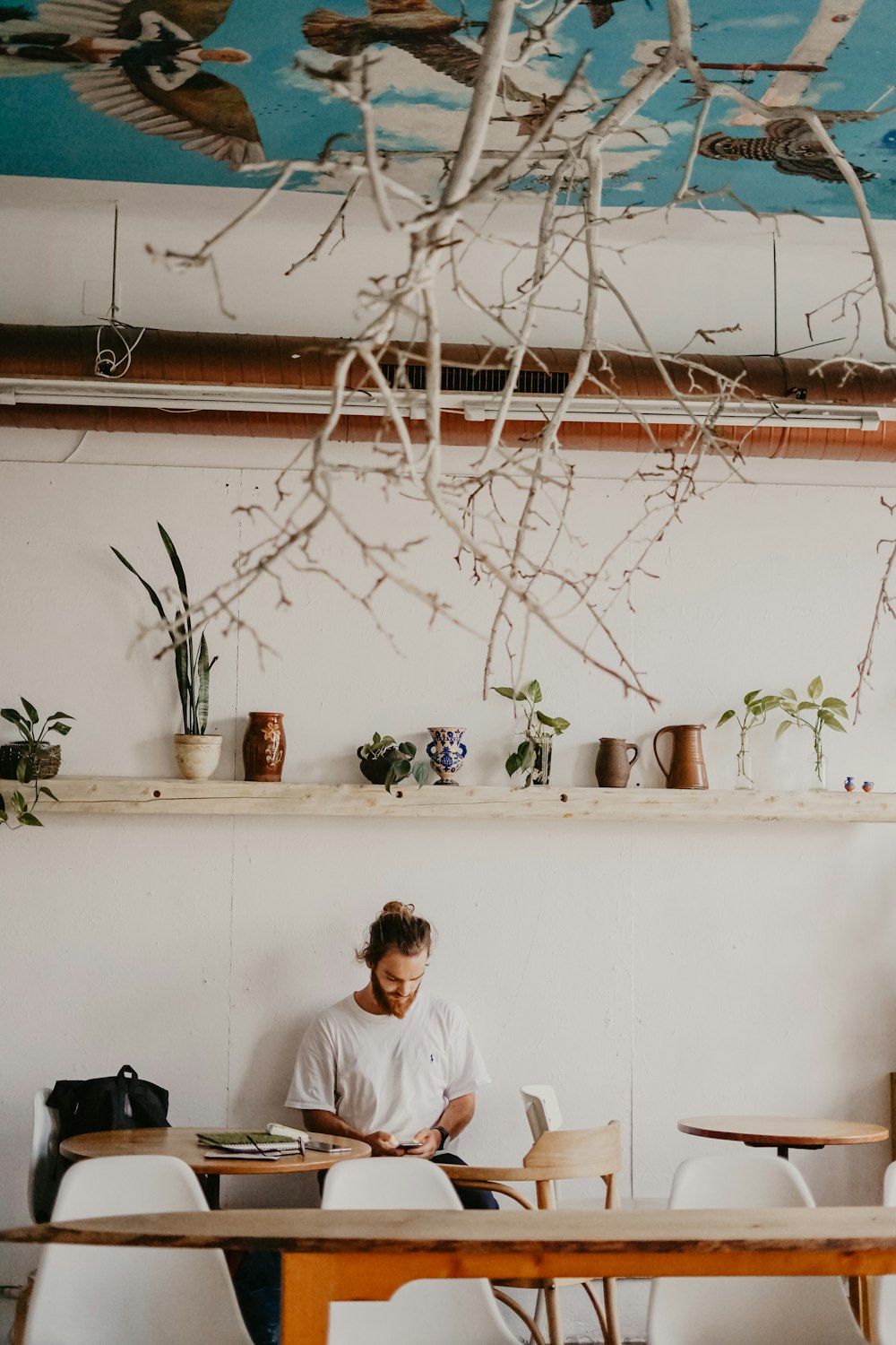 man standing beside painted wall