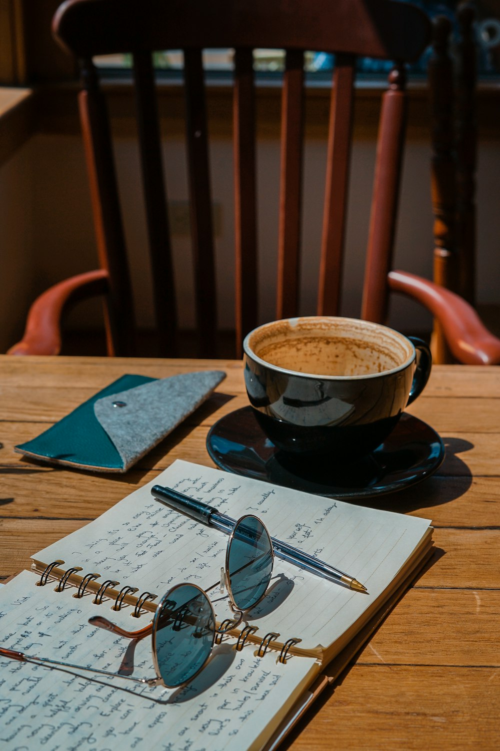 black ceramic mug beside notebook