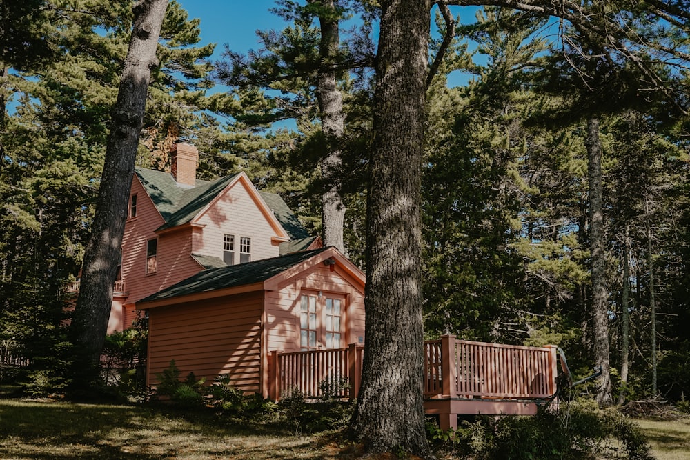 light pink and green cabin with balcony