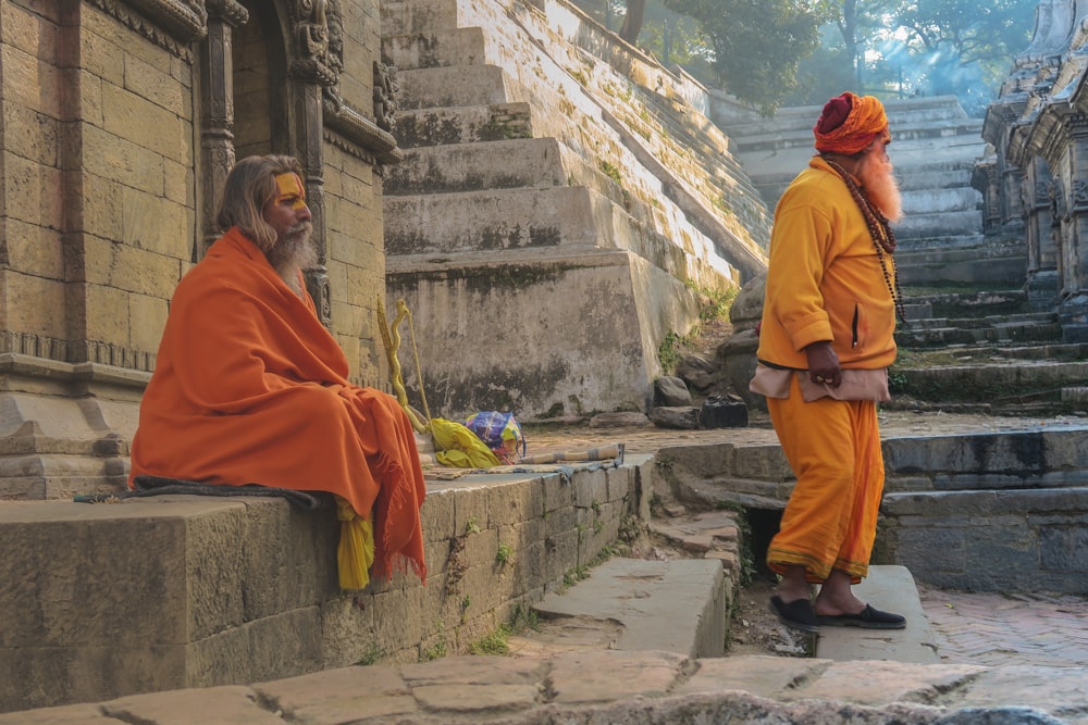 man wearing orange robe meditate