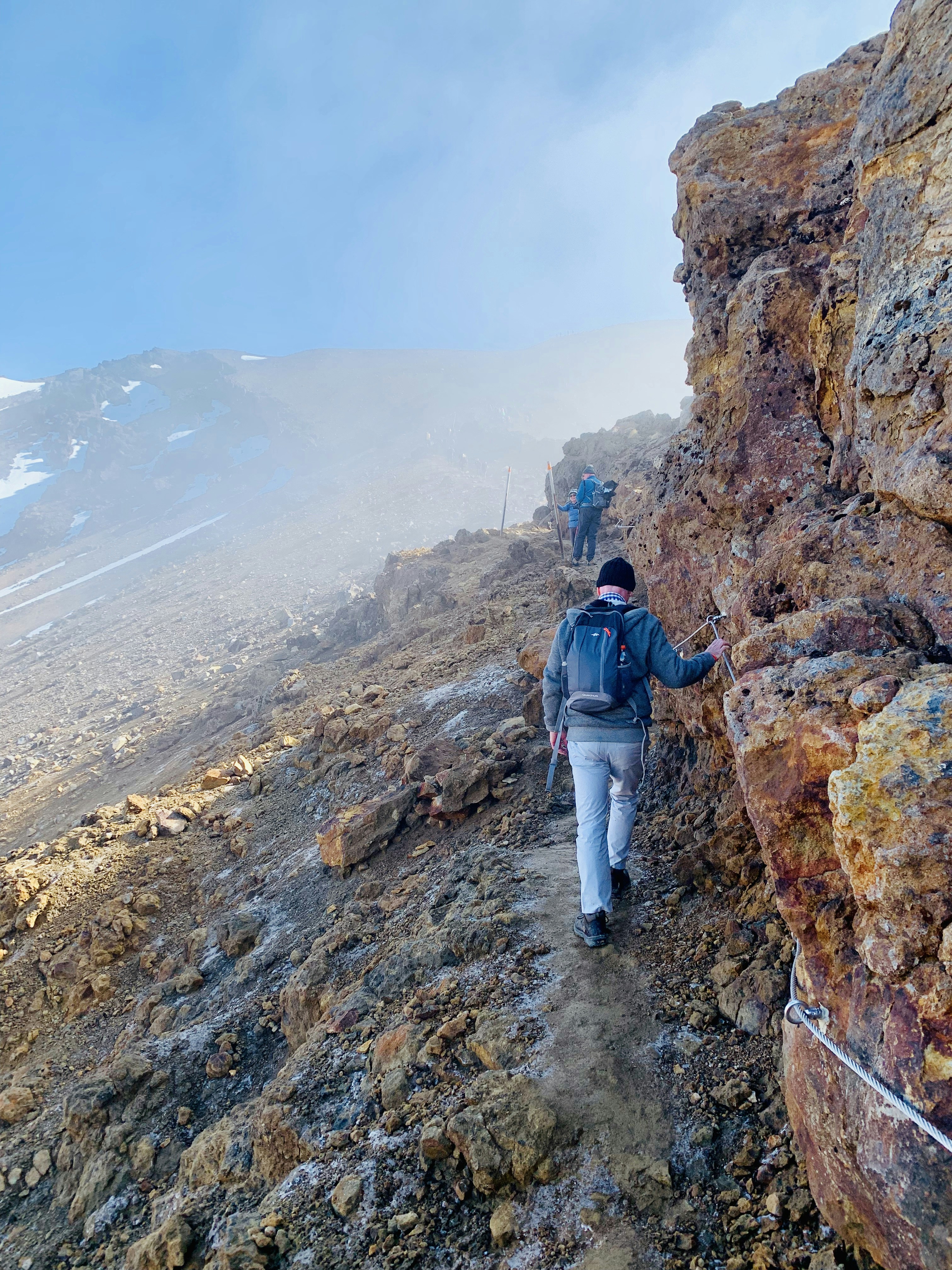 two men walking rocky mountain