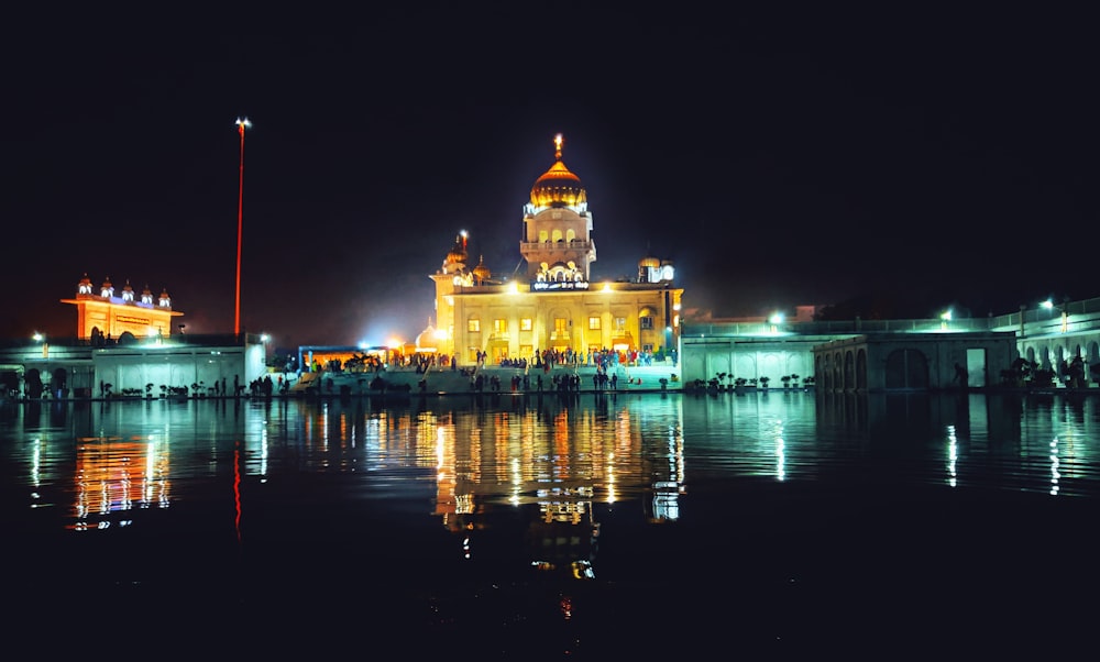 lighted building near body of water