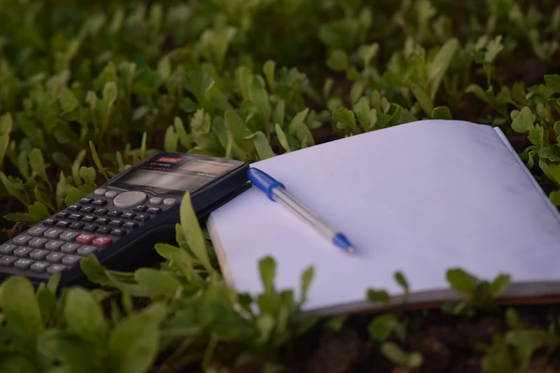 Pen on paper beside a calculator