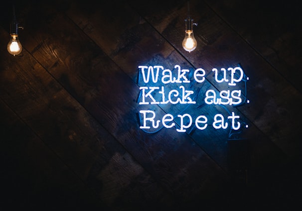 blue wake up kick ass repeat neon sign