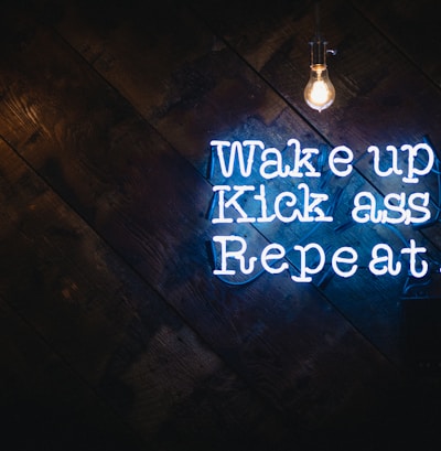 blue wake up kick ass repeat neon sign