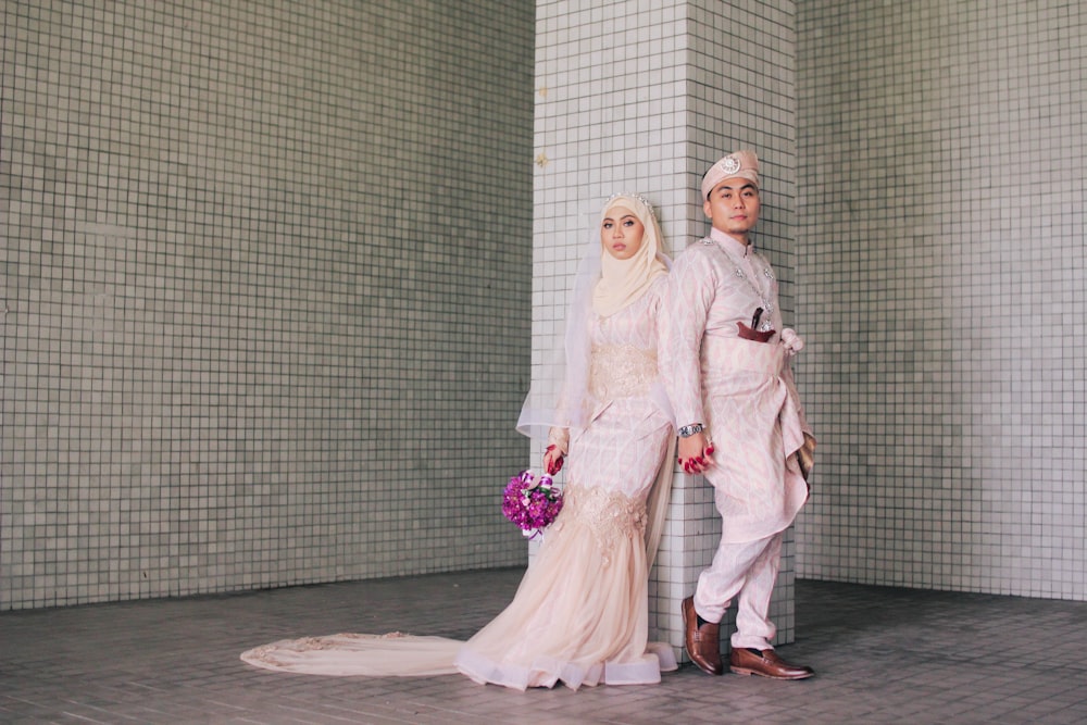 man and woman standing near concrete post